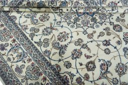 Surface texture of 2000s Nain rug with natural Wool and intricate pattern