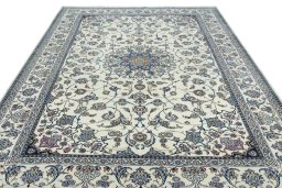 Surface texture of 2000s Nain rug with natural Wool and intricate pattern