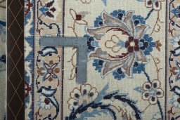 Backside of handmade 2000s Nain rug showing knot structure and weave density
