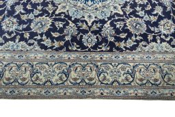 Corner detail of 2000s Nain rug showing border pattern and Wool pile