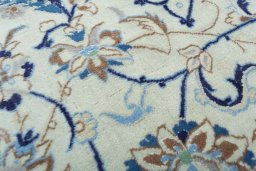 Surface texture of 2000s Nain rug with natural Wool and intricate pattern