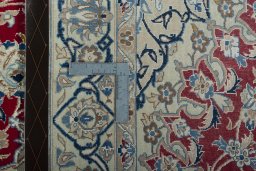 Backside of handmade 2000s Nain rug showing knot structure and weave density