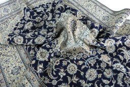 Surface texture of 2000s Nain rug with natural Wool and intricate pattern
