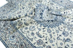 Surface texture of 2000s Nain rug with natural Wool and intricate pattern