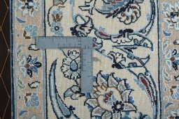 Backside of handmade 2000s Nain rug showing knot structure and weave density