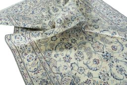 Surface texture of 2000s Nain rug with natural Wool and intricate pattern