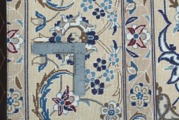 Backside of handmade 2000s Nain rug showing knot structure and weave density