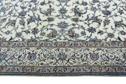 Corner detail of 2000s Nain rug showing border pattern and Wool pile