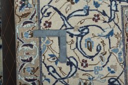 Backside of handmade 2000s Nain rug showing knot structure and weave density