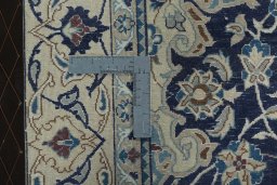 Backside of handmade 2000s Nain rug showing knot structure and weave density