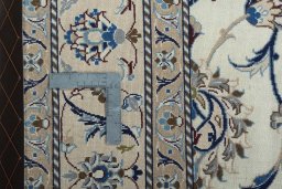 Surface texture of 1970s Nain rug with natural Wool and intricate pattern