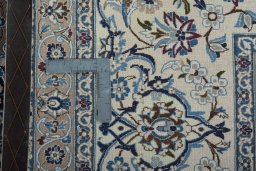 Backside of handmade 1970s Nain rug showing knot structure and weave density