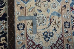 Backside of handmade 1970s Nain rug showing knot structure and weave density