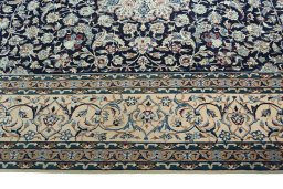 Corner detail of 2000s Nain rug showing border pattern and Wool pile