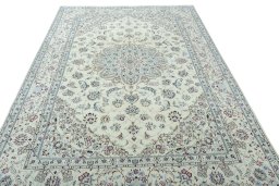 Surface texture of 2000s Nain rug with natural Wool and intricate pattern