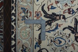 Backside of handmade 2000s Nain rug showing knot structure and weave density