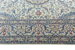 Corner detail of 2000s Nain rug showing border pattern and Wool pile