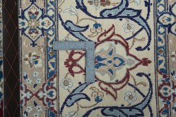 Backside of handmade 2000s Nain rug showing knot structure and weave density