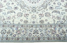 Corner detail of 2000s Nain rug showing border pattern and Wool pile