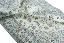 Surface texture of 2000s Nain rug with natural Wool and intricate pattern
