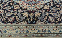 Corner detail of 2000s Nain rug showing border pattern and Wool pile