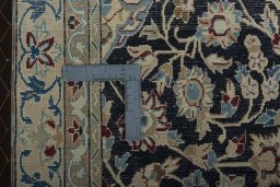Backside of handmade 2000s Nain rug showing knot structure and weave density
