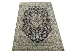 Surface texture of 2000s Nain rug with natural Wool and intricate pattern