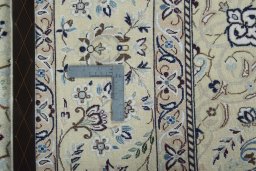 Backside of handmade 2000s Nain rug showing knot structure and weave density