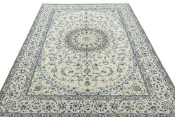 Surface texture of 2000s Nain rug with natural Wool and intricate pattern
