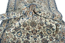 Surface texture of 2000s Nain rug with natural Wool and intricate pattern