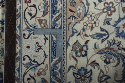 Backside of handmade 2000s Nain rug showing knot structure and weave density