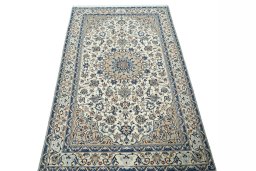 Surface texture of 2000s Nain rug with natural Wool and intricate pattern