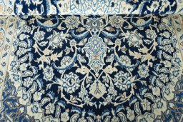 Corner detail of 2000s Nain rug showing border pattern and Wool pile