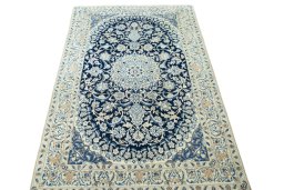 Surface texture of 2000s Nain rug with natural Wool and intricate pattern