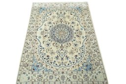 Surface texture of 2000s Nain rug with natural Wool and intricate pattern