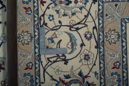 Backside of handmade New Nain rug showing knot structure and weave density