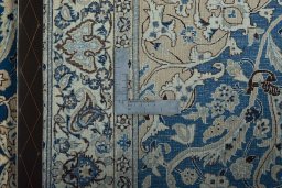 Backside of handmade 1950s Nain rug showing knot structure and weave density