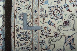 Backside of handmade New Nain rug showing knot structure and weave density