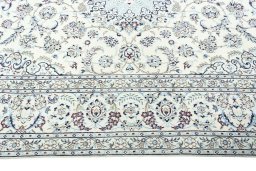 Corner detail of 2000s Nain rug showing border pattern and Wool pile