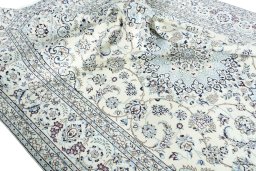 Surface texture of 2000s Nain rug with natural Wool and intricate pattern