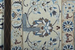 Backside of handmade New Nain rug showing knot structure and weave density