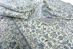 Surface texture of 2000s Nain rug with natural Wool and intricate pattern