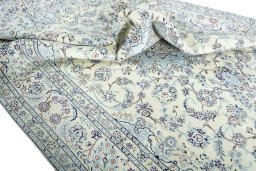 Surface texture of 2000s Nain rug with natural Wool and intricate pattern