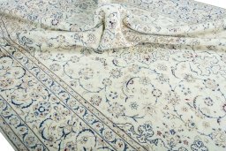 Surface texture of 2000s Nain rug with natural Wool and intricate pattern