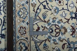 Backside of handmade New Nain rug showing knot structure and weave density