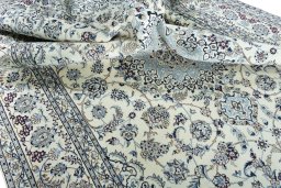 Surface texture of 2000s Nain rug with natural Wool and intricate pattern