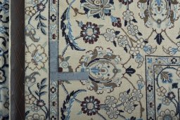 Backside of handmade 2000s Nain rug showing knot structure and weave density