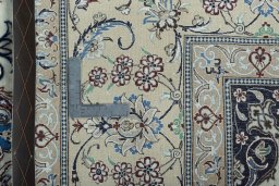 Backside of handmade New Nain rug showing knot structure and weave density