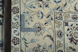 Backside of handmade 2000s Nain rug showing knot structure and weave density