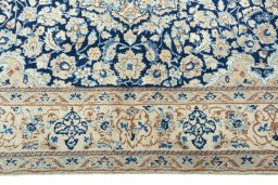 Corner detail of 2000s Nain rug showing border pattern and Wool pile